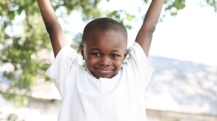 boy with his arms in the air