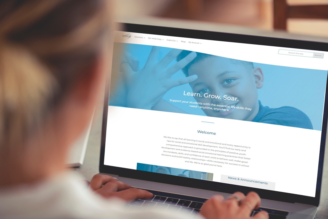 A teacher looks at her laptop