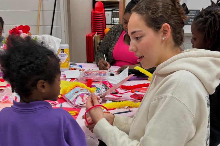 school children lined up in front of brick wall