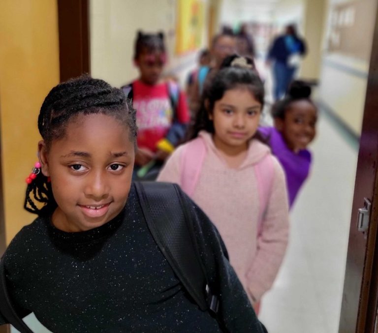 Kids in line looking at camera