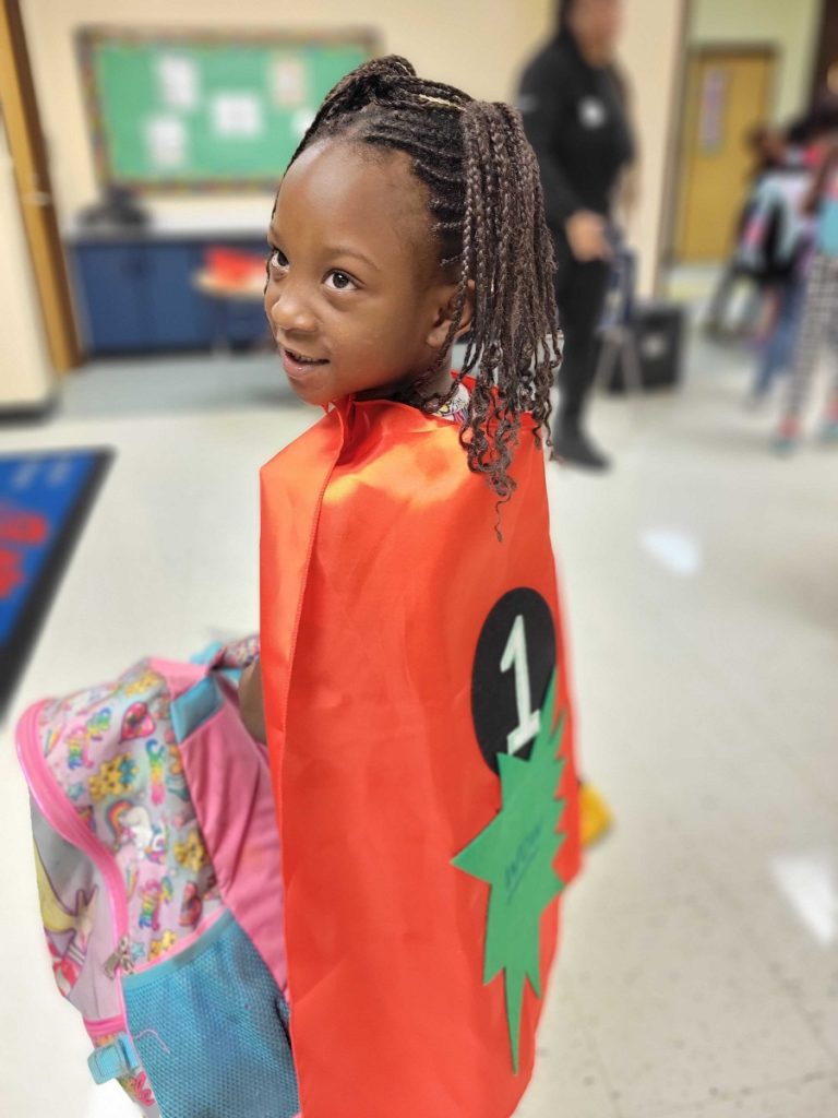 Little girl in superhero cape