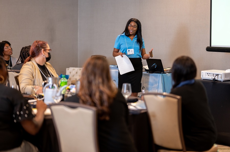 Cheryl speaks in front of group