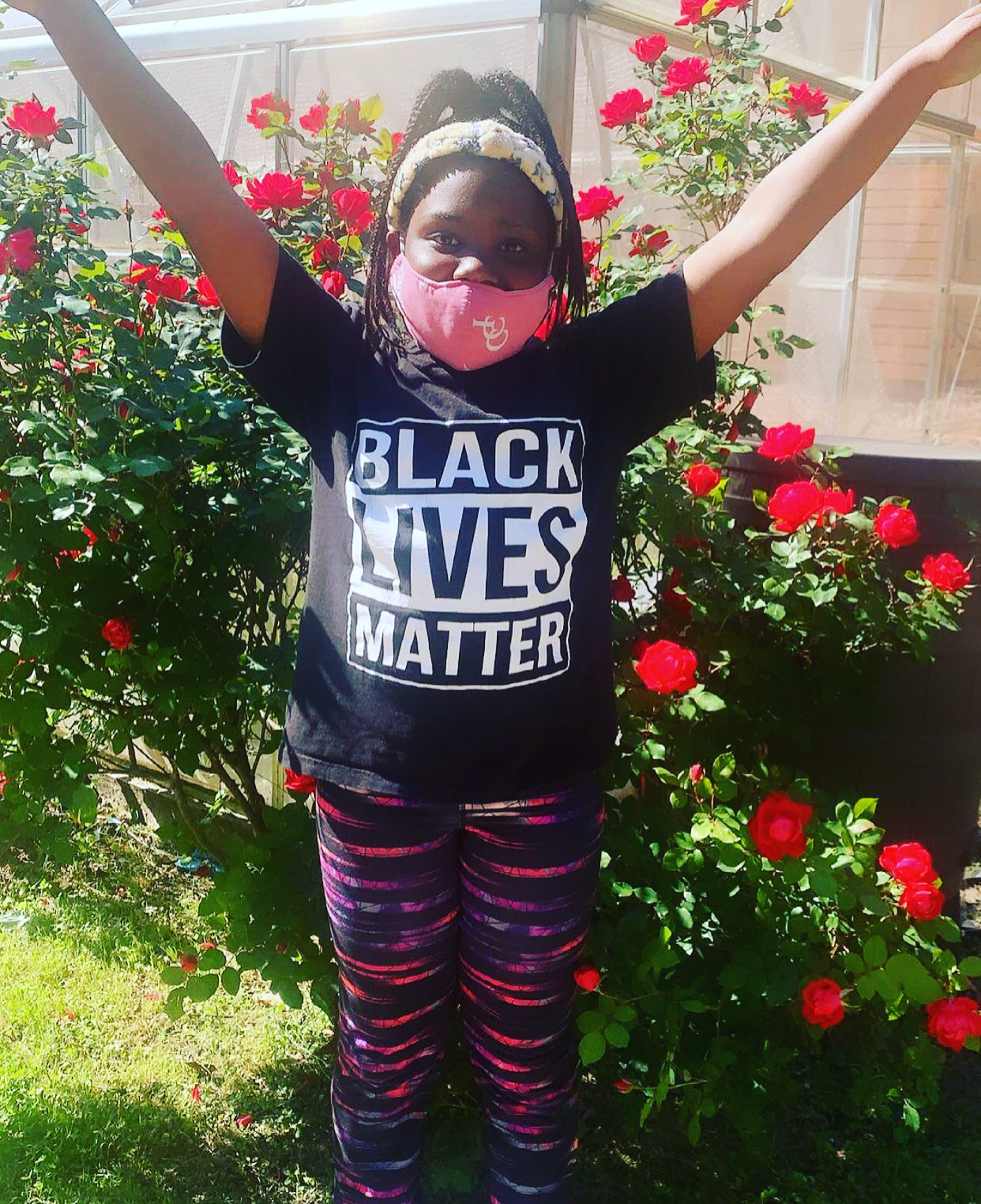 Young girl wearing raising her arms like wings