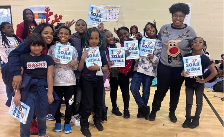 school children lined up in front of brick wall