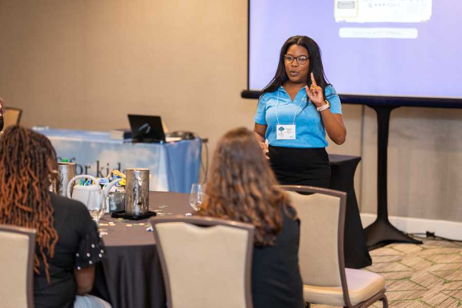 Three school boys represent Wings by making Ws with their hands.