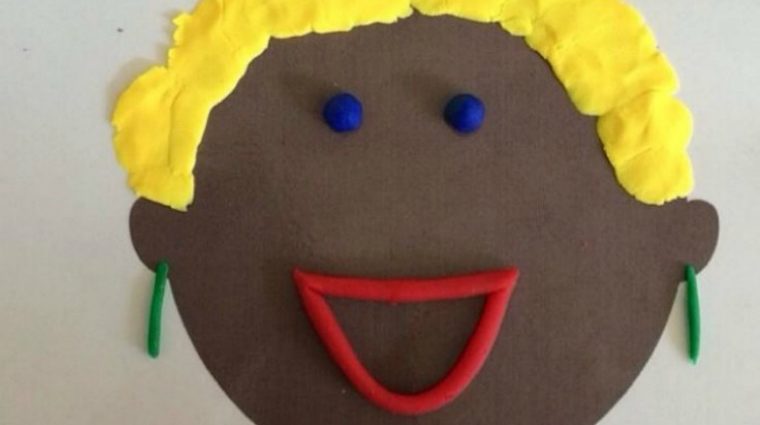 school children lined up in front of brick wall