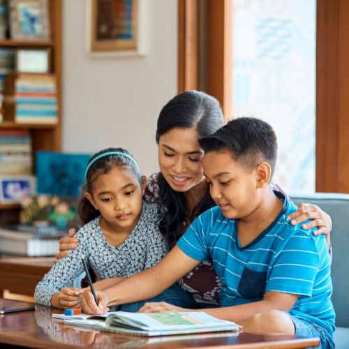 A mother and kids looking at a workbook