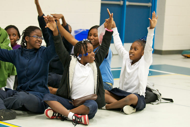A group of kids with arms outstretched